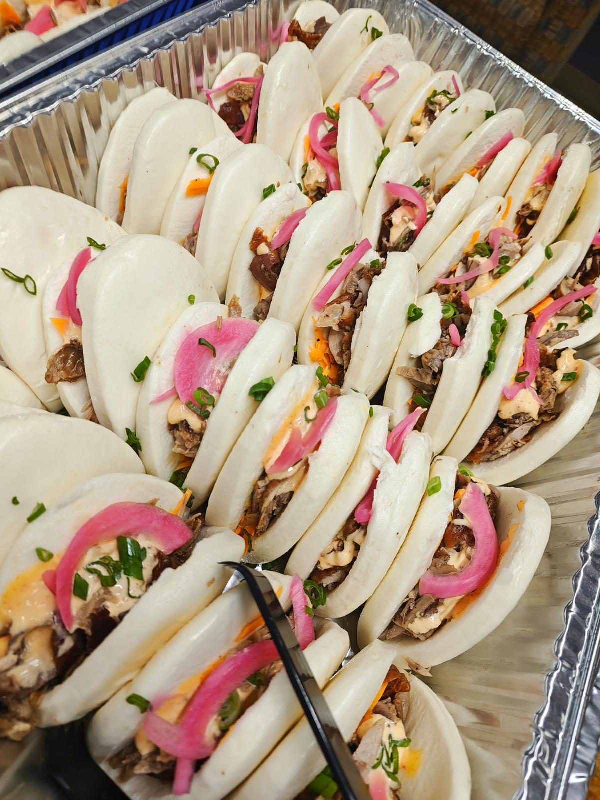 Tray of Himalayan bao buns with pickled onions
